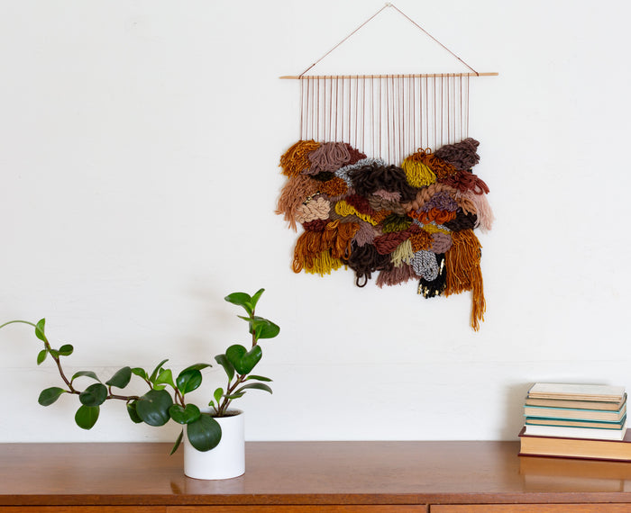 Cedarville wall hanging displayed in bright modern space — artisan fiber decor with layered organic textures.