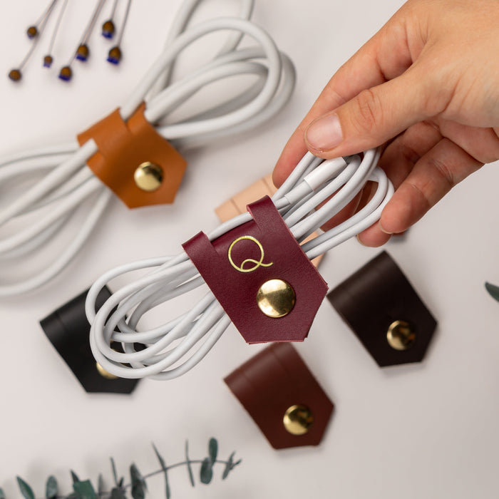 Hand-finished leather cable keepers in Wine, Black, Nicotine, Chocolate and Walnut tones, Keyaiira cord organizers for charging cables, USB cords, device wires and electronics storage
