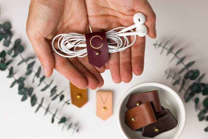 Wine full-grain leather earbud keeper with customized C initial, artisan-finished by Keyaiira for wired headphones, charging cords, small electronics and tangle-free travel storage