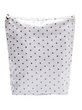 White pouch with black polka dots on a white background