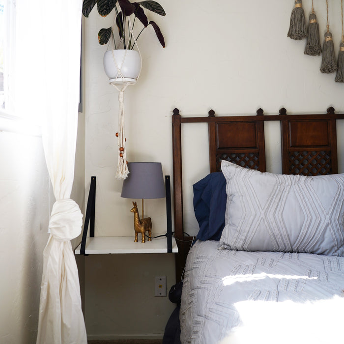 Keyaiira standard width leather wall straps installed as a statement headboard accent — handcrafted tan leather wall brackets adding warm, modern farmhouse character to bedroom decor.