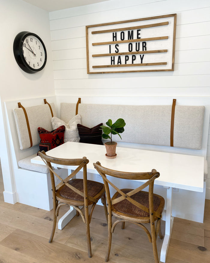 Keyaiira standard width leather wall straps securing upholstered dining nook cushions — handcrafted leather cushion straps creating functional, modern farmhouse wall-mounted seating.