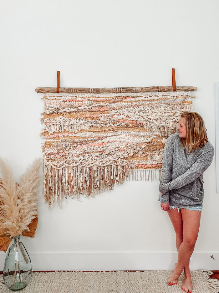 Leather wall straps supporting woven textile wall art — custom standard width leather brackets adding earthy, modern boho texture to wall decor.