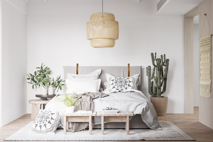 Keyaiira custom leather wall straps used to mount a neutral upholstered headboard — handcrafted tan leather loops for modern bedroom styling.