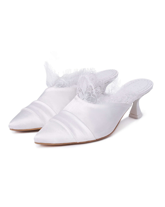 A clear view of two pairs of heeled slippers standing together on a clean white background.