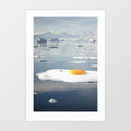 Surreal art print of a sunny-side-up egg melting on an iceberg — quirky climate change wall art for kitchens and modern interiors