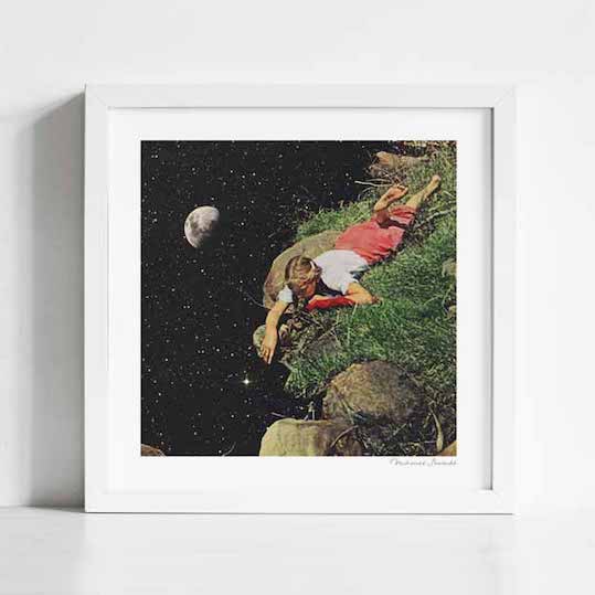 Felt art print framed view — surreal collage of child and cosmos, girl touching the edge of space from a clifftop, whimsical galaxy wall art for nurseries and collectors