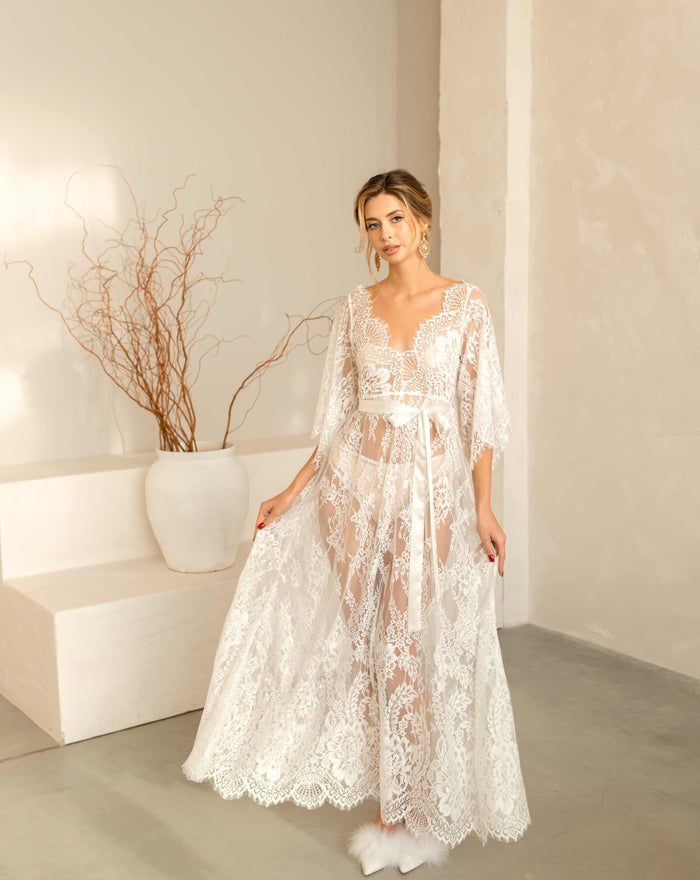 A shot of the Flora lace nightdress with the model lifting the hem to show the flowing, airy fabric.
