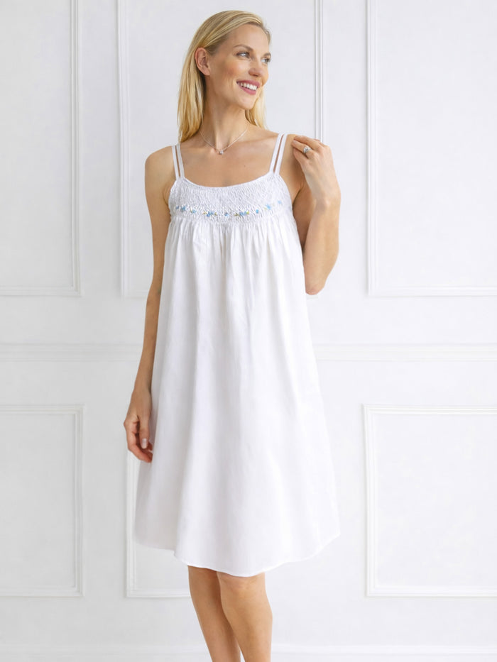 Woman wearing a white nightgown against a white background