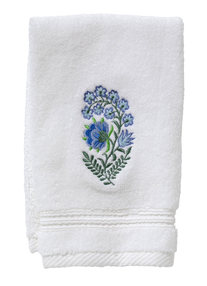 White towel with blue floral embroidery on a white background