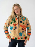 Woman wearing a colorful jacket with abstract patterns on a white background