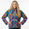 Woman wearing a colorful embroidered jacket on a white background
