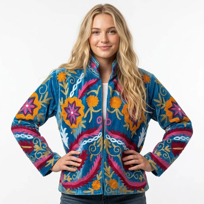 Woman wearing a colorful embroidered jacket on a white background