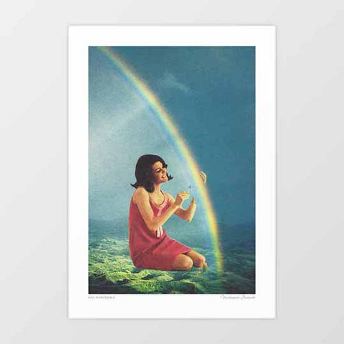 High Maintenance surreal art print vertical — 1960s woman in pink red dress kneeling on green foliage cupping a delicate flower or butterfly in her hands as a spectacular double rainbow arches across a dramatic blue grey sky behind her, surreal vintage romantic atmospheric art print for bold eclectic interiors