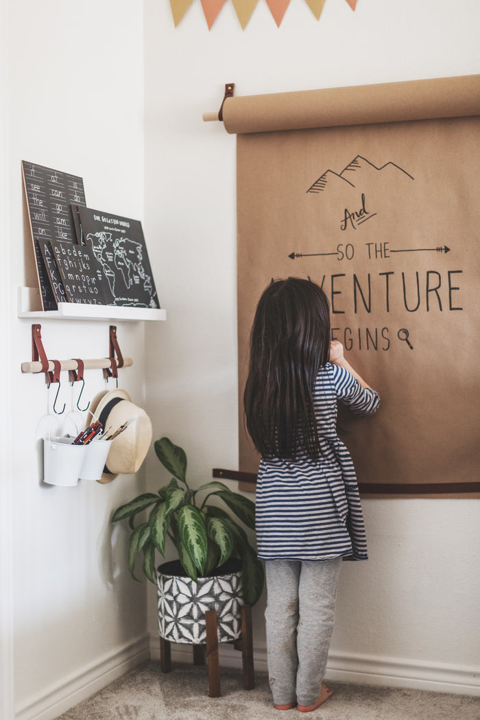 Entryway wall rail with leather loops and hooks used for bags and accessories — modern handcrafted wall organization for small spaces.