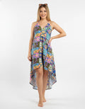 Woman wearing a colorful patterned dress on a white background