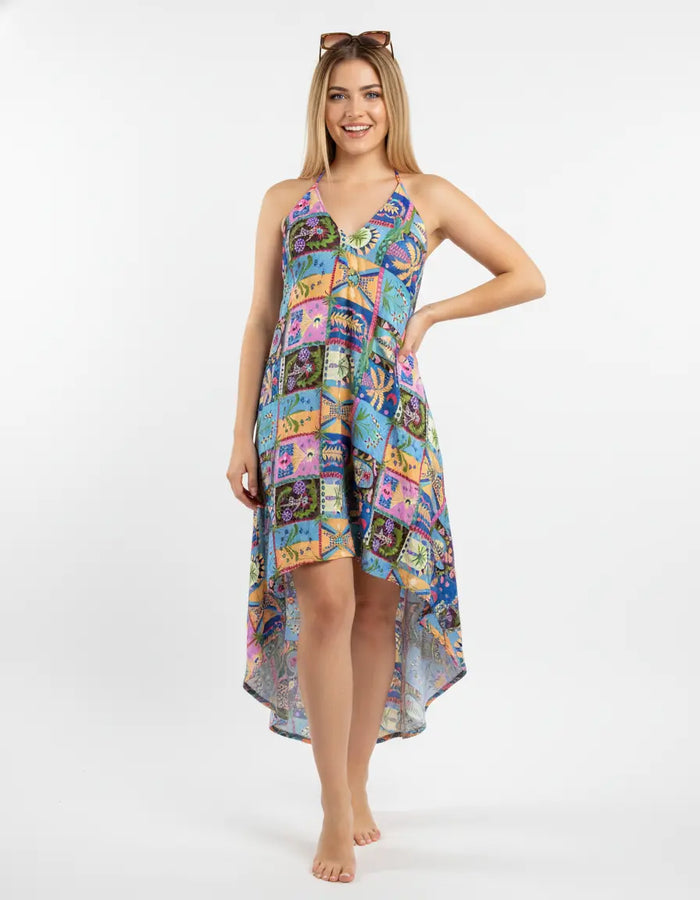 Woman wearing a colorful patterned dress on a white background