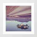 Surreal art print of a figure leaning against an upside-down vintage car suspended beneath an inverted desert highway - quirky retro wall art