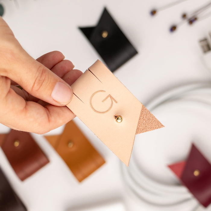 Customized letter G Veg Tan leather cord keeper with Stud & Post hardware, designed for large charging cables, power cords, device cables and everyday tech organization by Keyaiira