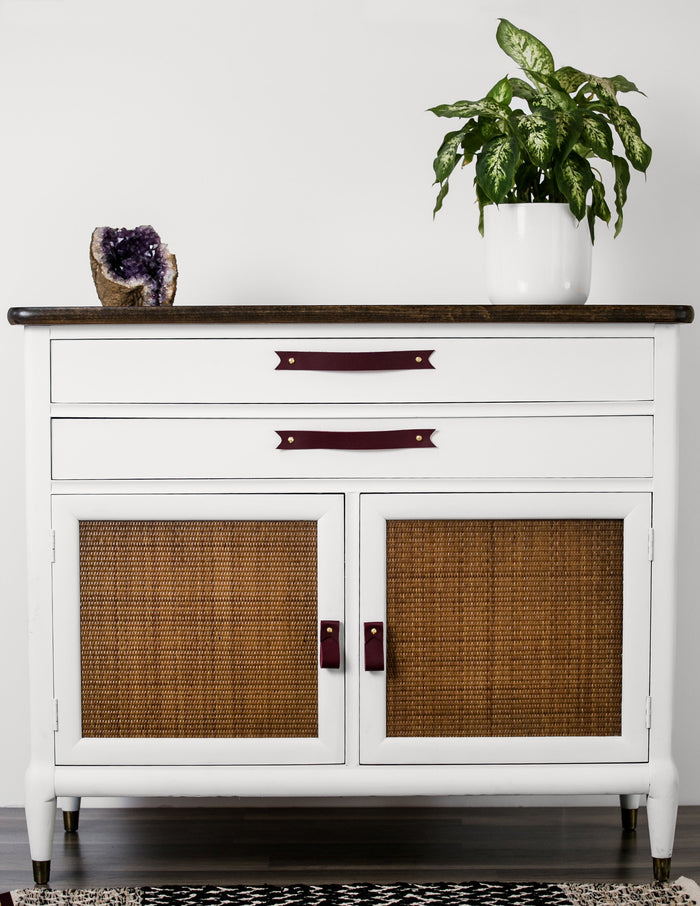 Keyaiira burgundy leather cabinet handles with brass hardware installed on white dresser — contemporary leather drawer pulls for bedroom storage furniture.