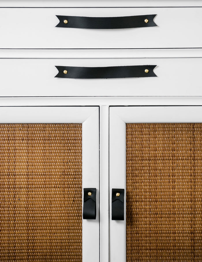 Keyaiira leather cabinet handles installed on white kitchen drawers near window — minimalist leather pulls for modern kitchen cabinetry.