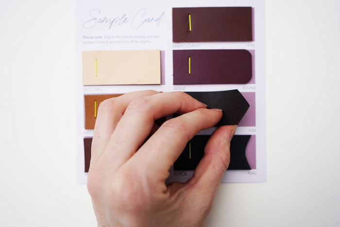 Keyaiira Leather Color Chart seven leather swatches in black, walnut, mahogany, nicotine, veg-tan, chocolate, and wine. Visual guide showing patina development of vegetable-tanned leather over time.