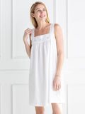 Woman wearing a white nightgown against a white background