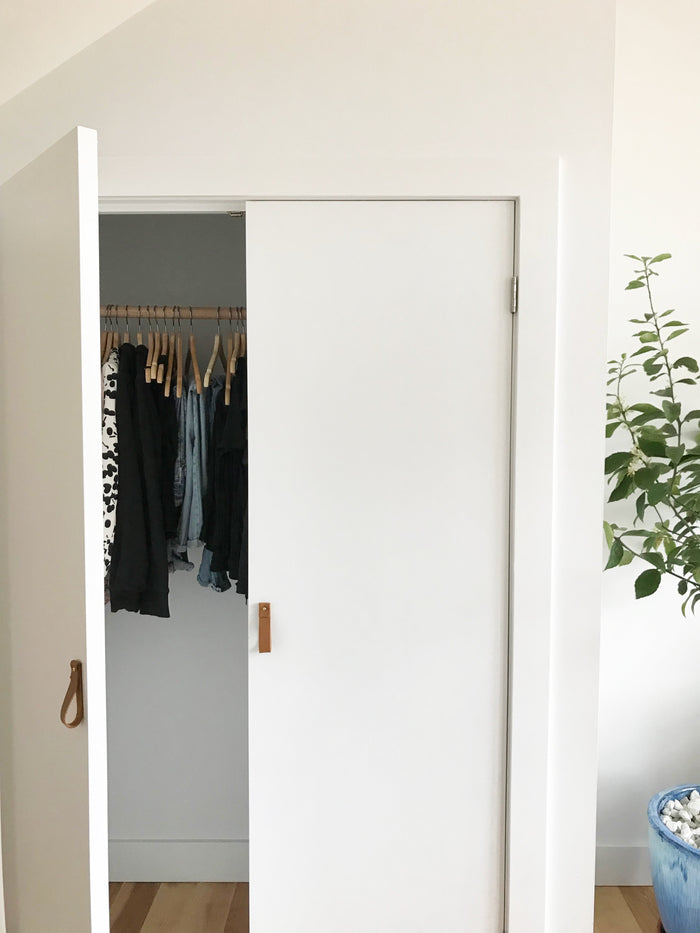 Keyaiira tan leather cabinet pulls on white closet doors handcrafted leather handles for minimal, natural home styling.