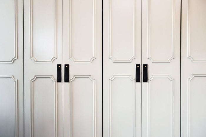 Keyaiira black leather cabinet pulls on white wardrobe handcrafted leather loop handles with brass screws for clean, modern design.