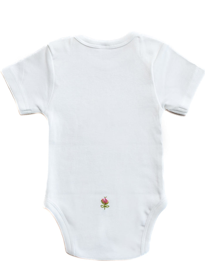 White baby onesie with a small embroidered design on a white background