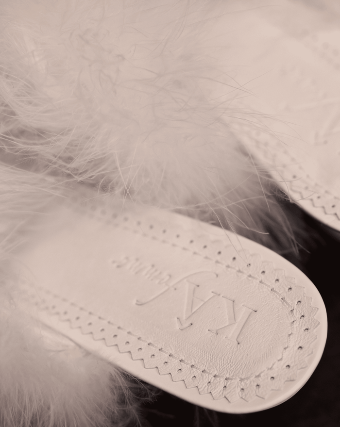 Close-up of the genuine leather insole featuring the brand engraving and soft padding for cloud-like comfort.