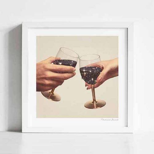 Primordial Wine art print framed view — two hands toasting with gold wine glasses containing sparkling star-filled galaxies against a cream background, cosmic romantic anniversary wall art for restaurants boutique hotels and gallery walls