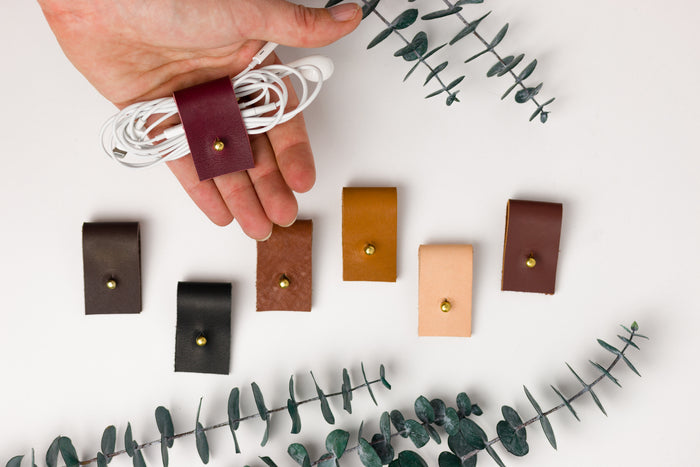Small leather cord wraps in a range of Keyaiira colors, hand-finished organizers for headphones, charging wires, electronic accessories and convenient cable storage at home or on the go