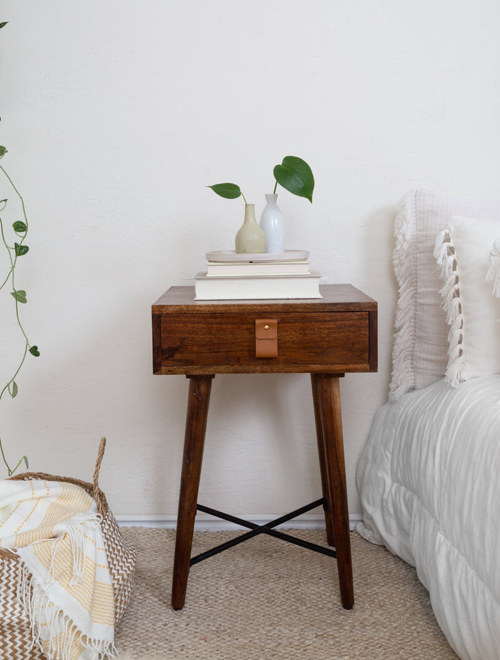 Keyaiira small wide leather pull on walnut drawer, photographed in soft shadowed lighting to highlight the deep brown tones of the handcrafted furniture hardware.
