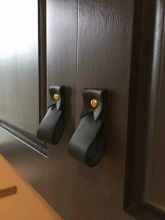 Keyaiira black leather wall straps mounted on dark wood cabinet doors with solid brass hardware, modern minimalist leather cabinet hooks for kitchen or bathroom organization.