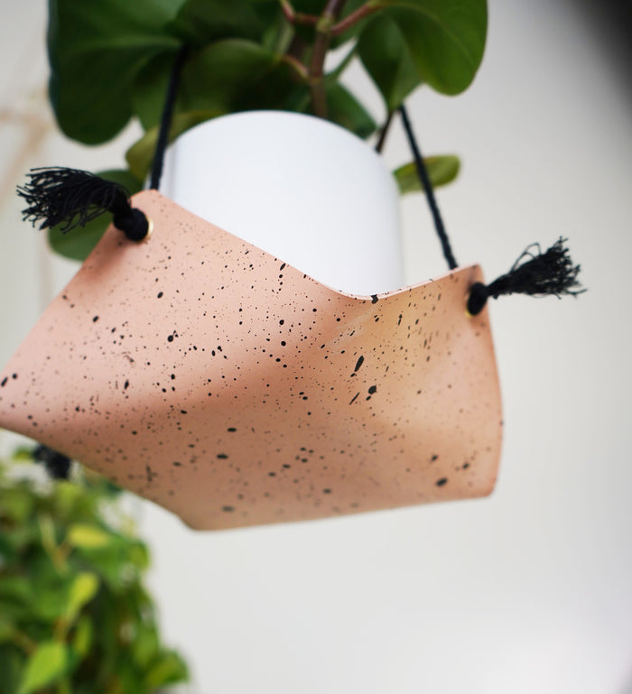 Close-up of Keyaiira speckled leather hanging planter showing texture and black cord detail. Modern handcrafted leather plant holder for indoor greenery.