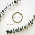 Steel metal ring shown with 2.5-inch size reference — durable circular hardware for leather straps, towel rings, wall-mounted storage, and hanging systems.