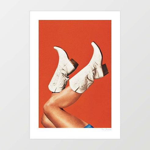 Surreal art print of white cowgirl boots with legs kicked in the air against a rich burnt orange terracotta background – These Boots Burnt Orange by Vertigo Artography
