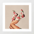 Surreal art print of floral cowgirl boots covered in pink roses and green leaves with legs kicked in the air against a warm neutral background – These Boots Floral by Vertigo Artography