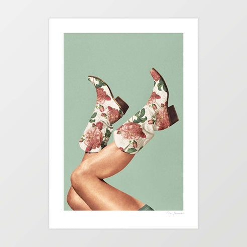 Surreal art print of floral cowgirl boots with pink roses and green leaves kicked in the air against a soft sage green background – These Boots Floral Boho Green by Vertigo Artography