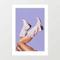 Surreal art print of sparkling glitter cowgirl boots with legs kicked in the air against a periwinkle lavender background – These Boots Glitter Very Peri by Vertigo Artography