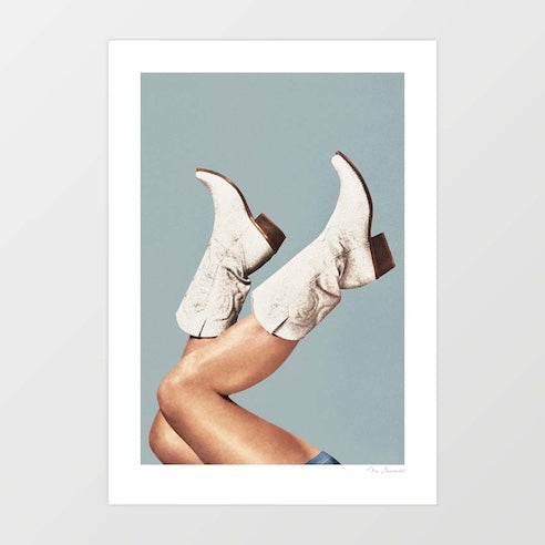 Contemporary art print of white embroidered cowgirl boots with legs kicked in the air against a cool steel blue-grey background – These Boots Gray Blue by Vertigo Artography