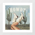 Surreal art print of white cowgirl boots kicked in the air among saguaro cacti under a dusty blue sky with bold Howdy typography – These Boots Howdy Cactus by Vertigo Artography