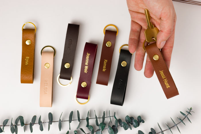 Thick leather loop keychains in assorted colors with brass ring hardware — personalized custom key fobs in vegetable-tanned leather.