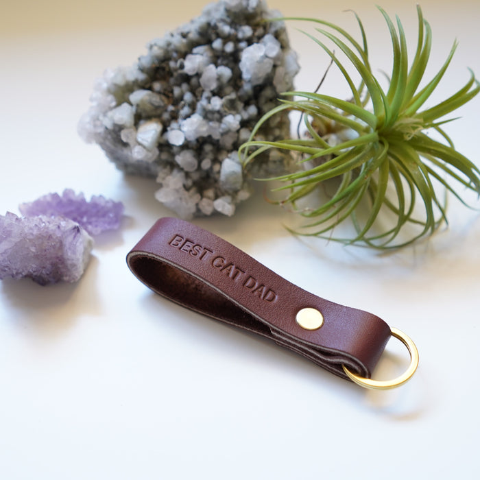 Personalized thick leather keychain with gold foil name engraving — durable loop key fob with brass hardware.