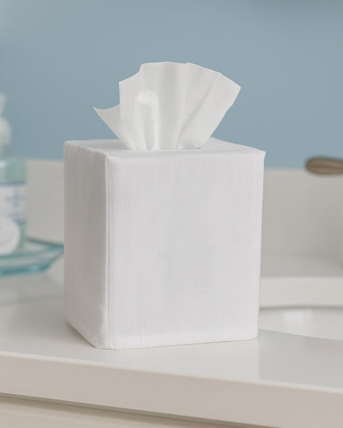 Box of tissues on a bathroom counter with a blue wall in the background