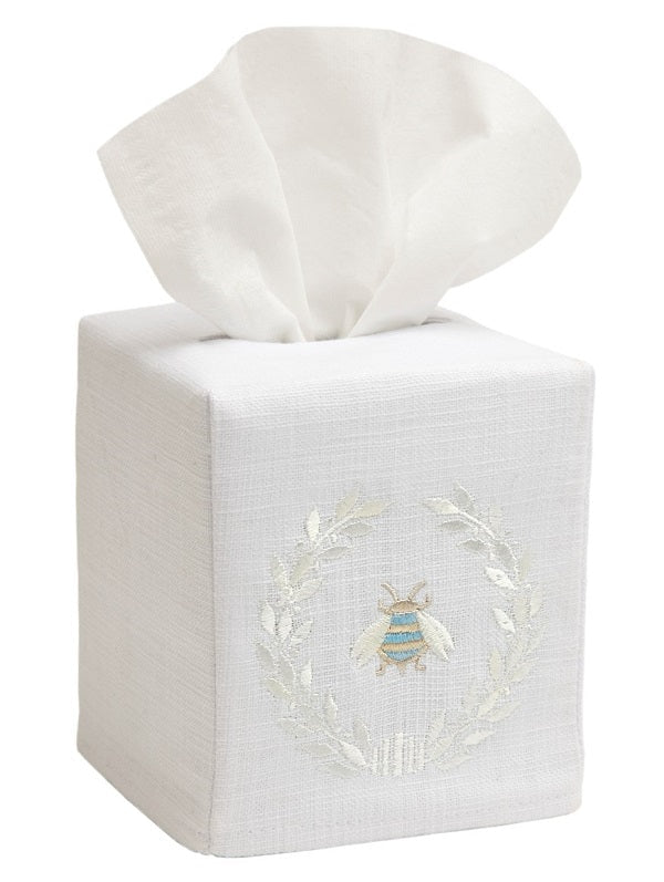 White tissue box cover with embroidered design on a white background
