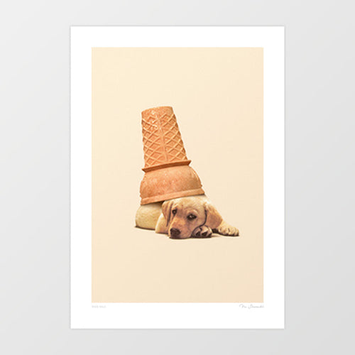 Under Dog surreal art print — golden Labrador puppy lying flat with chin on paws and an upturned golden waffle ice cream cone balanced on its head, warm cream minimal background, whimsical cute dog wall art for puppy lovers and dog lover interiors