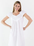 Woman wearing a white nightgown on a white background