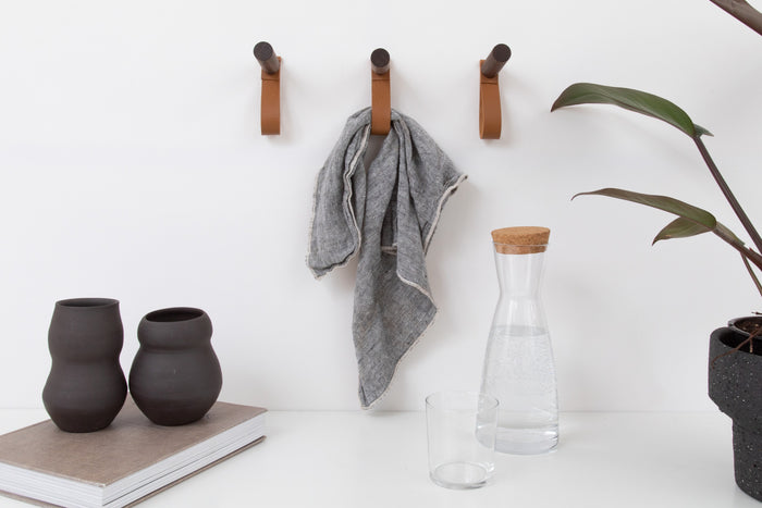 Handcrafted leather wall peg with wooden dowel — modern minimalist hanging hook for towels, bags, or home organization.
